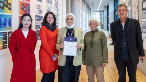 Dua's - Dennis Holt Travel Prize Winner stood with supporting staff